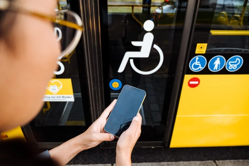 women getting on a seat in bus for specially abled passengers